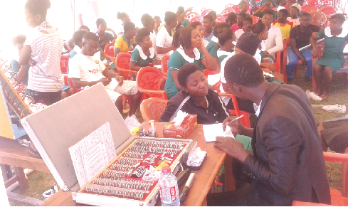 Dr Felix Awuriki (right) interacting with one of the students during the health screening at JAPASS Dr Felix Awuriki (right) interacting with one of the students during the health screening at JAPASS